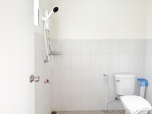 a bathroom with a shower with a toilet at Jira Hotel in Lampang