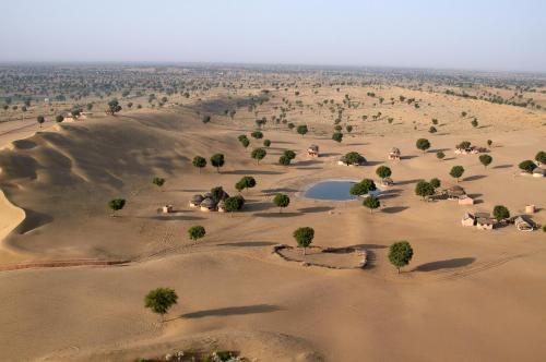 an aerial view of a desert with a lake in the middle at Welcomhotel by ITC Hotels, Fort & Dunes, Khimsar in Khimsar