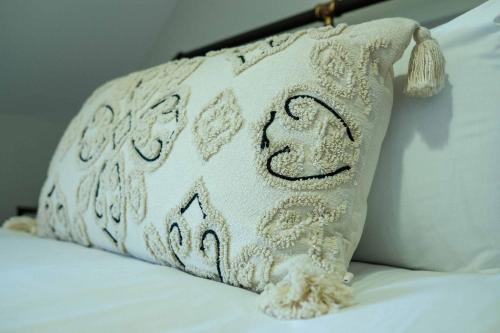 a white pillow sitting on top of a bed at The Willow - Studio 22 in Bristol