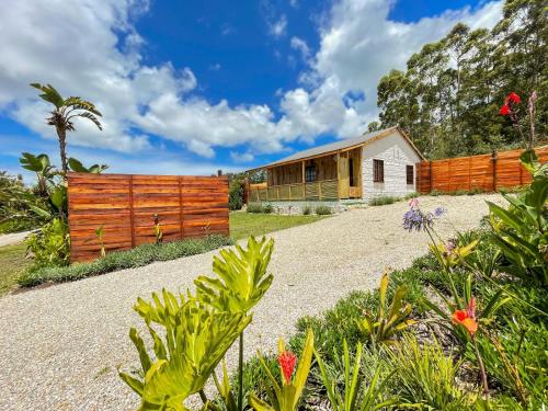 a house with a wooden fence and a garden at Adventurer's Escape HQ in Harkerville