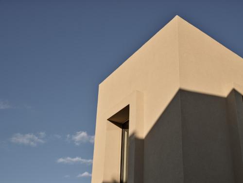 a white building with a blue sky in the background at Vorto Luxury Villas, a Signature Island Retreat, By ThinkVilla in Zakynthos
