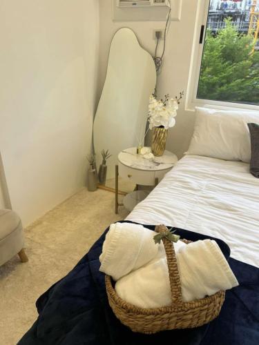 a bedroom with a bed with a basket on it at Matina Enclaves Residences in Davao City