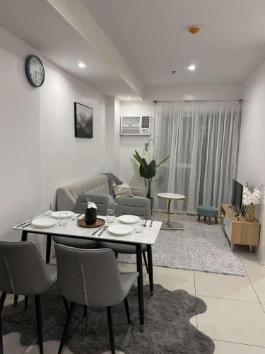 a living room with a table and chairs and a couch at Matina Enclaves Residences in Davao City