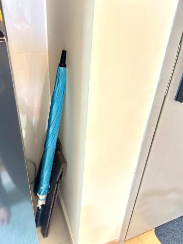 a blue umbrella is in a closet at La Dimora Gamuda Cove Splash Mania in Pulau Kempas
