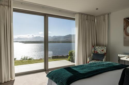 a bedroom with a bed and a large window at Benguela Cove - Lavender Dreams in Hermanus
