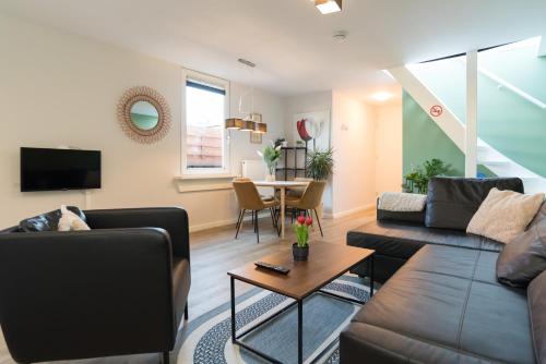 a living room with a couch and a table at Alkmaar City Apartments in Alkmaar