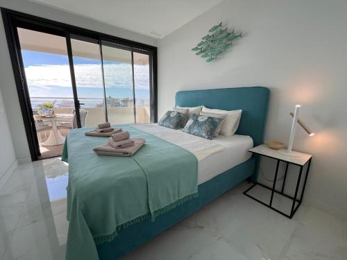 a bedroom with a bed with a view of the ocean at Benidorm Beach apartment - Costa Blanca in Benidorm