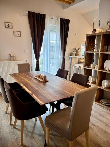 a dining room with a wooden table and chairs at Garden House in Kranj