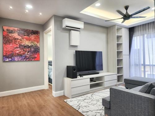 a living room with a television and a ceiling fan at Villa Ayer Keroh Swimming Pool by DefineSuite in Ayer Keroh