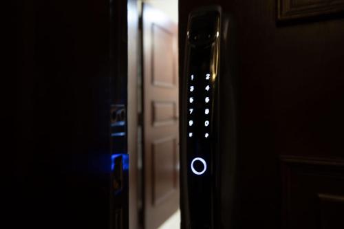a close up of a door with a blue light at شقة فندقية - كورنيش المعادي تاور ريزيدنت in Cairo