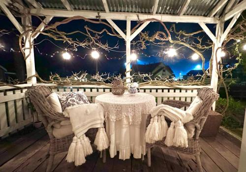a table and chairs under a gazebo at night at The Old Bakery in Historic Kangaroo Valley Village in Kangaroo Valley