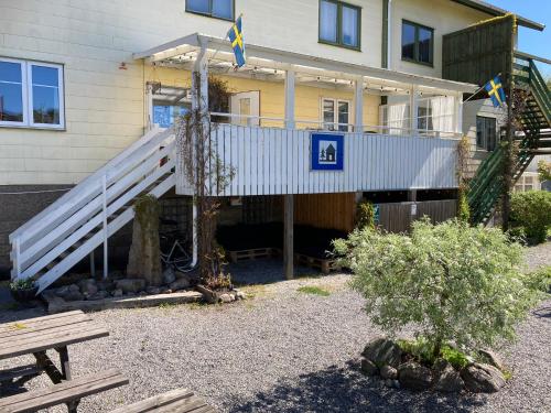 a house with a white staircase in front of it at Kustnära Vandrarhem in Hamburgsund