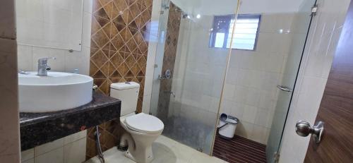 a bathroom with a toilet and a sink and a shower at Thai Stays Villa in Shenwa