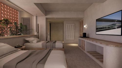 a bedroom with two beds and a flat screen tv at La Gaia - Adult Only in Alanya