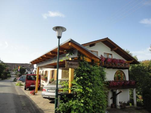 a building with a street light next to it at Pension Andrea in Sankt Peter im Sulmtal