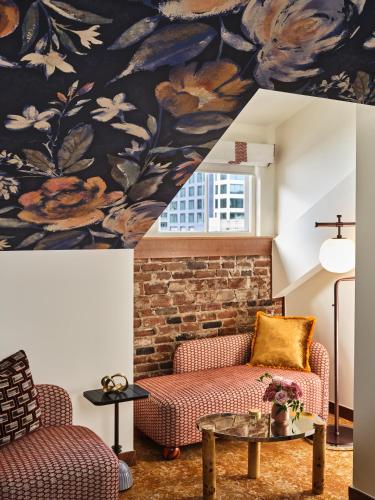 a living room with a couch and a table at The Crawford Hotel in Denver