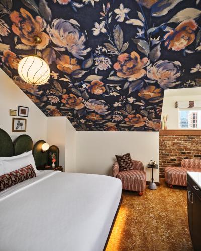 a bedroom with a large bed and a floral ceiling at The Crawford Hotel in Denver
