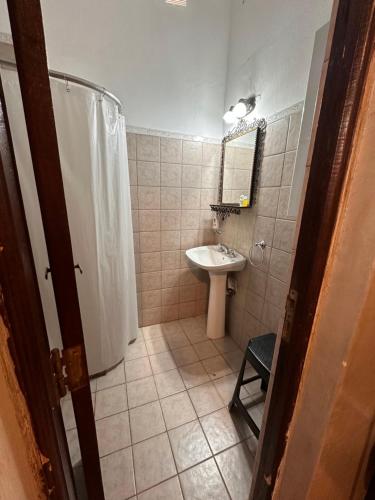 a bathroom with a sink and a shower curtain at LO DE CAPRETTA in Almafuerte