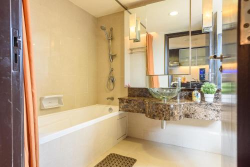 a bathroom with a sink and a bath tub at Resort Suites at Pyramid Tower by GL Staycation in Petaling Jaya