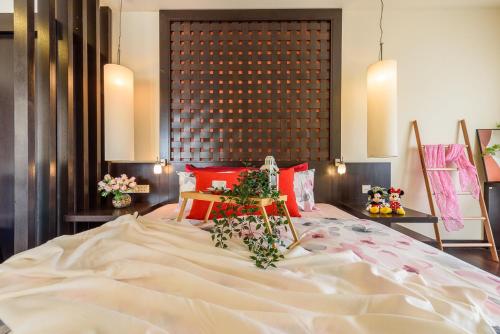 a bedroom with a large white bed with flowers on it at Resort Suites at Pyramid Tower by GL Staycation in Petaling Jaya
