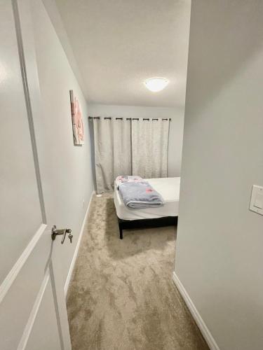 a small bedroom with a bed in a room at Best home in Oshawa in Oshawa