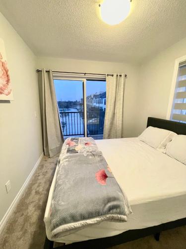 a bedroom with a bed and a window with a view at Best home in Oshawa in Oshawa