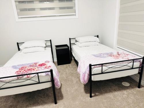 a bedroom with two beds and a window at Best home in Oshawa in Oshawa