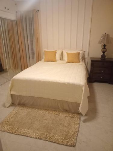 a large bed in a bedroom with a rug on the floor at Virginias Place in The Valley