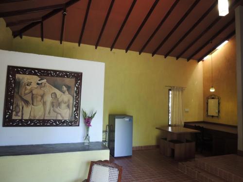a room with a painting on the wall and a table at The Residence Bentota in Bentota
