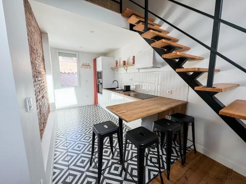 une cuisine avec un escalier, une table et des tabourets dans l'établissement Studio - Le Duplex Catalan - App 3-3 - City center, à Perpignan