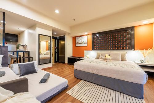 a bedroom with two beds and a living room at Resort Suites at Pyramid Tower by GL Staycation in Petaling Jaya