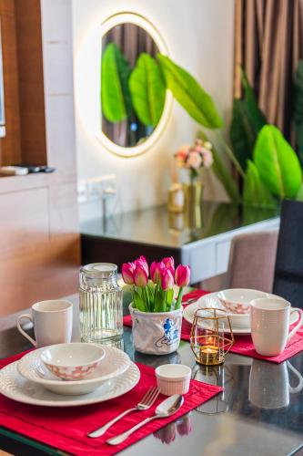 a table with two plates and a red napkin at Resort Suites at Pyramid Tower by GL Staycation in Petaling Jaya