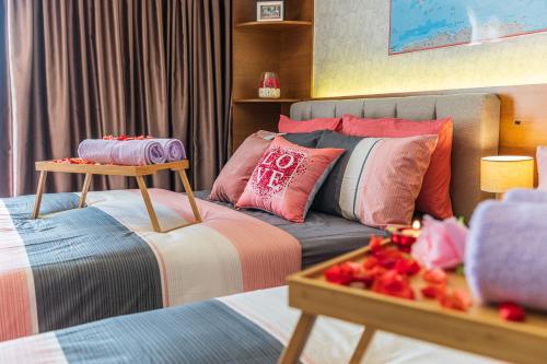 a living room with two beds and a couch at Resort Suites at Pyramid Tower by GL Staycation in Petaling Jaya