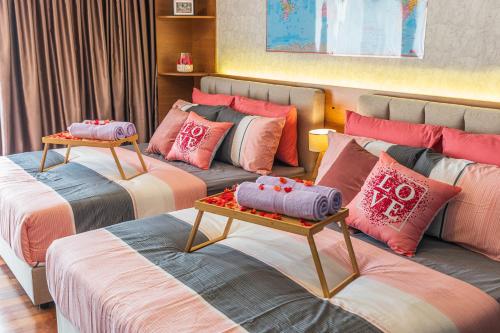 a room with three beds with pillows on them at Resort Suites at Pyramid Tower by GL Staycation in Petaling Jaya
