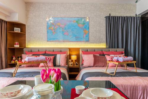 a bedroom with two beds and a map on the wall at Resort Suites at Pyramid Tower by GL Staycation in Petaling Jaya