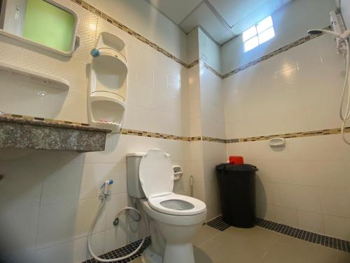 a bathroom with a white toilet and a sink at Jack's house Thara in Krabi