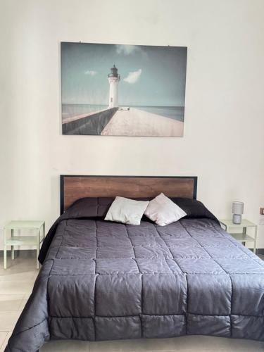 a bedroom with a bed with a lighthouse on the wall at Civico 19 Guest House -Free Wi-Fi- in Salerno