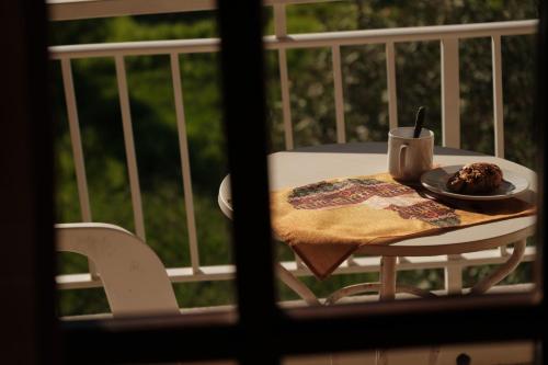 a plate of food on a table on a balcony at SERENGETI NAP comfy rooms in Sidari