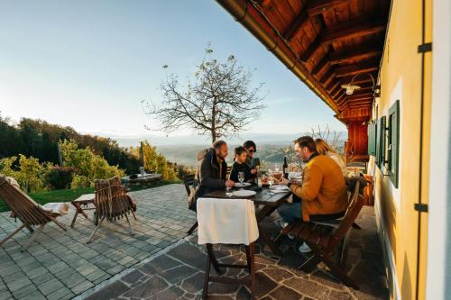 a group of people sitting at a table on a patio at Winzerhaus Oswald in Narrath