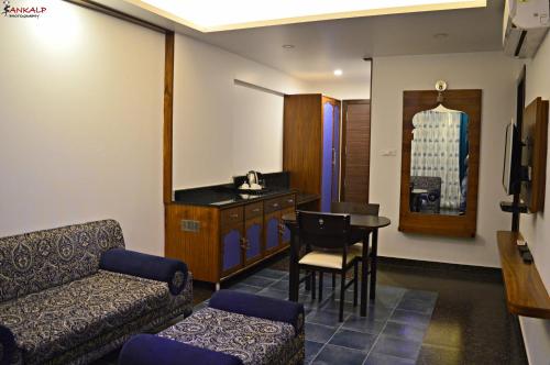 a living room with a couch and a table at Sepoy Grande Mysore in Mysore