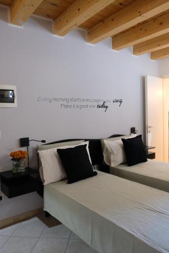two beds sitting next to each other in a room at Adria Art Apartments 2 in Adria