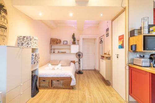 Cette petite chambre comprend un lit et une cuisine. dans l'établissement Cozy T1 with Wifi in the heart of Toulouse, à Toulouse