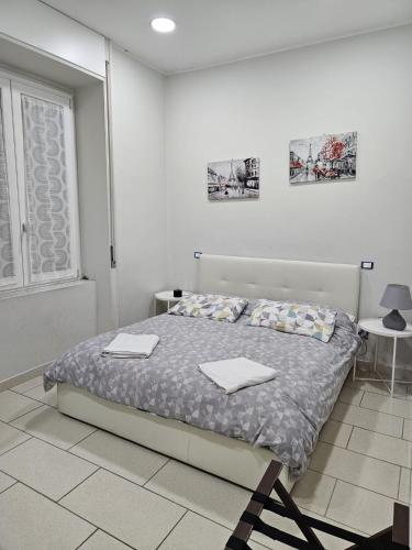 a bedroom with a bed with two towels on it at binario&tre in Eboli