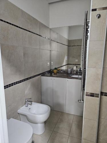 a bathroom with a white toilet and a sink at binario&tre in Eboli