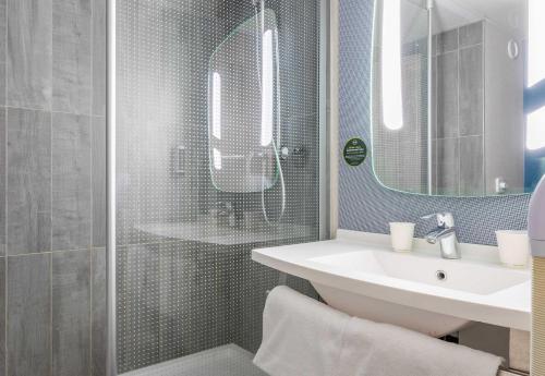 a bathroom with a sink and a shower at B&B HOTEL Marseille Bonneveine in Marseille