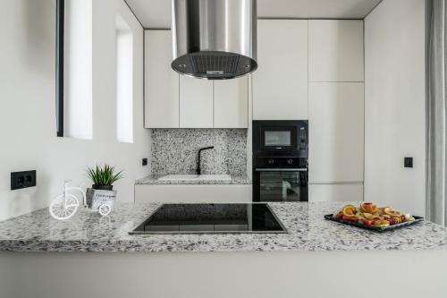 a kitchen with a plate of fruit on a counter at Vorto Luxury Villas, a Signature Island Retreat, By ThinkVilla in Zakynthos