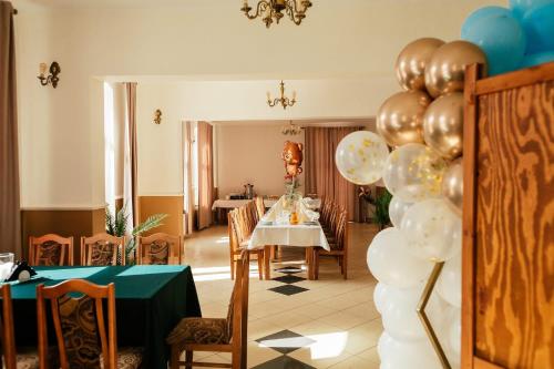a dining room with a table with balloons at Marysienka in Bisztynek