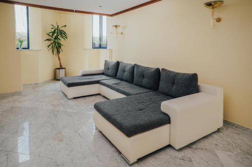 a living room with a couch and a table at Lechpark Hotel in Untermeitingen