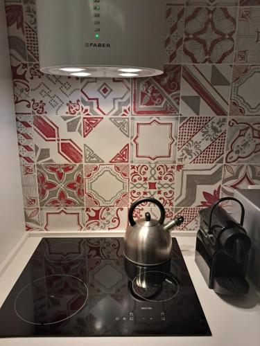 a tea kettle on top of a stove in a kitchen at La dimora dalle Mura in Savona
