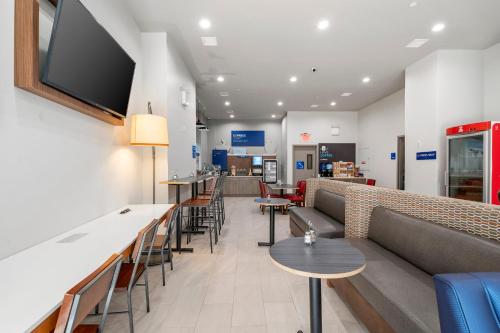a waiting room with a couch and chairs and tables at Holiday Inn Express & Suites Bronx - Zoo Area by IHG in Bronx